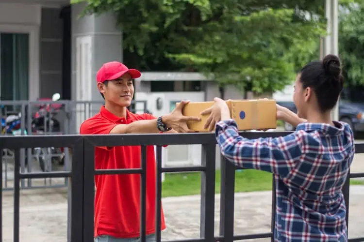 Karyawan Jasa Pengiriman Menyerahkan Barang Ke Pelanggan